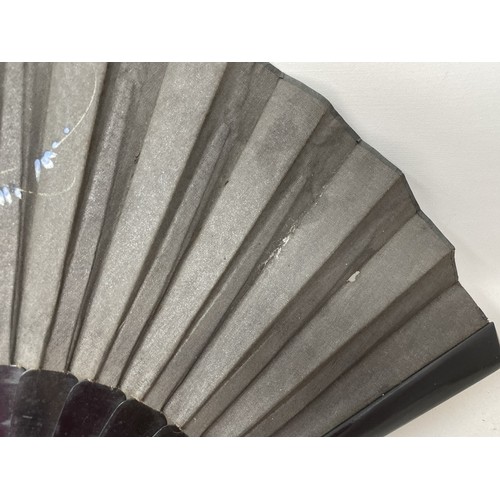 820 - An ebonised fan, the silk painted flowers, 25 cm, boxed, and five other fans (6)