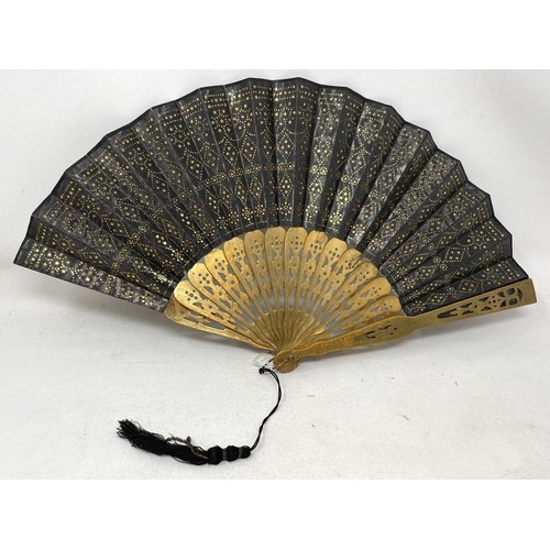 820 - An ebonised fan, the silk painted flowers, 25 cm, boxed, and five other fans (6)