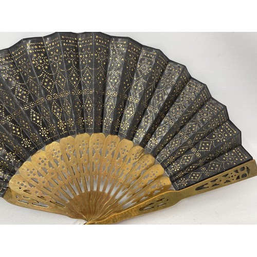 820 - An ebonised fan, the silk painted flowers, 25 cm, boxed, and five other fans (6)