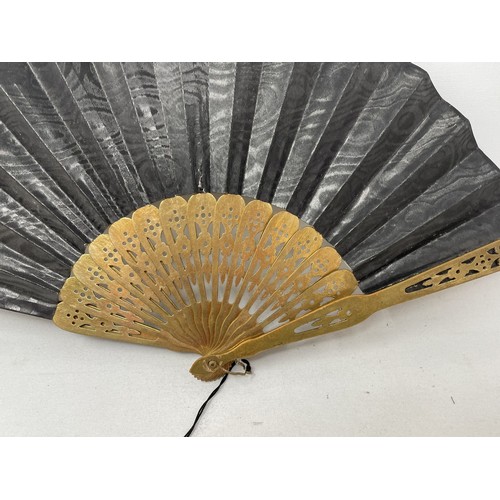 820 - An ebonised fan, the silk painted flowers, 25 cm, boxed, and five other fans (6)