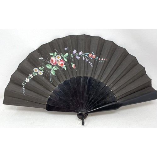 820 - An ebonised fan, the silk painted flowers, 25 cm, boxed, and five other fans (6)