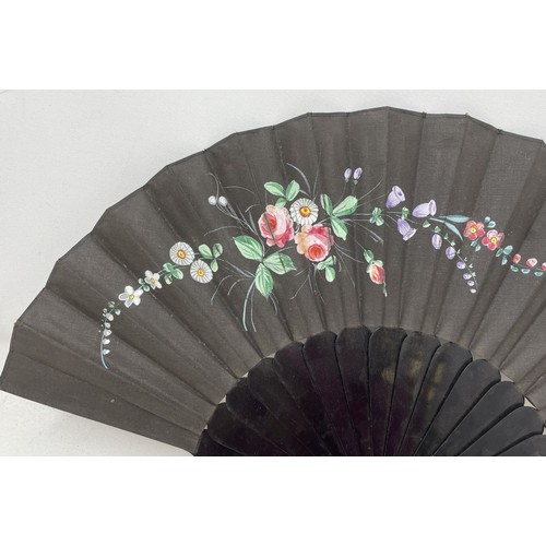 820 - An ebonised fan, the silk painted flowers, 25 cm, boxed, and five other fans (6)