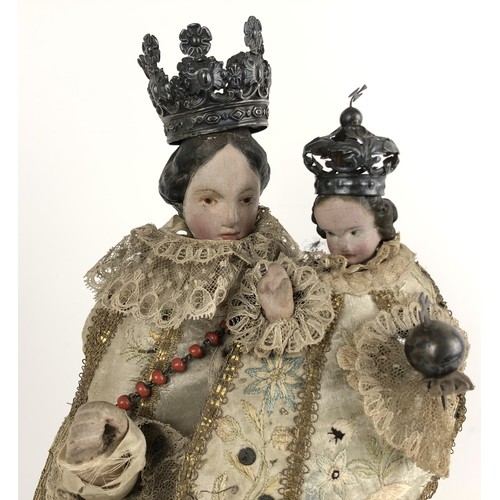 834 - An 18th century style group of the Madonna and Child, with silver coloured metal crowns and silk emb... 