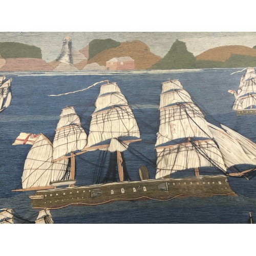 846 - A Victorian sailor woolwork panel, decorated steam and other ships, with a lighthouse in the distanc... 