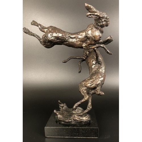 951 - ***Withdrawn*** A bronze group,  of two hares boxing, on a polished slate base, 24 cm high