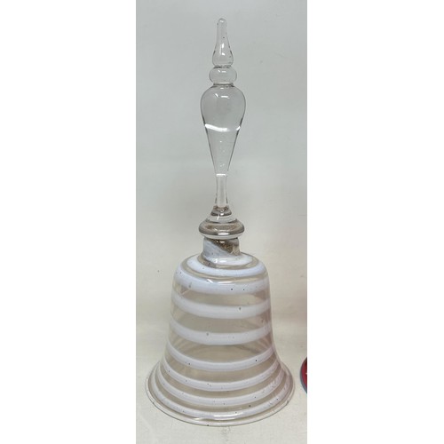 916 - A cranberry, opaque and clear glass bell, 28 cm, and another glass bell, lacking ringers