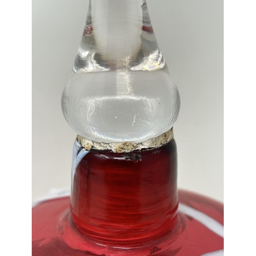 916 - A cranberry, opaque and clear glass bell, 28 cm, and another glass bell, lacking ringers