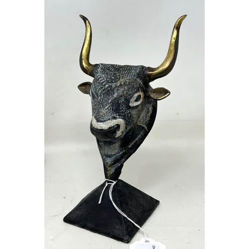 918 - An Egyptian style Sphinx, 25 cm wide, and a figure of a bull's head (2)