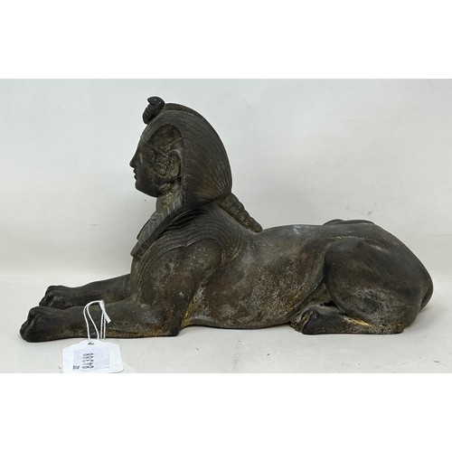 918 - An Egyptian style Sphinx, 25 cm wide, and a figure of a bull's head (2)