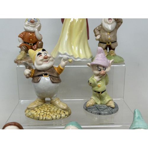 933 - A Royal Doulton set of Snow White and the Seven Dwarfs, No 1135, boxed with certificate, a Bunnykins... 