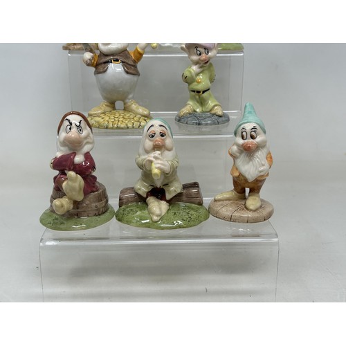 933 - A Royal Doulton set of Snow White and the Seven Dwarfs, No 1135, boxed with certificate, a Bunnykins... 