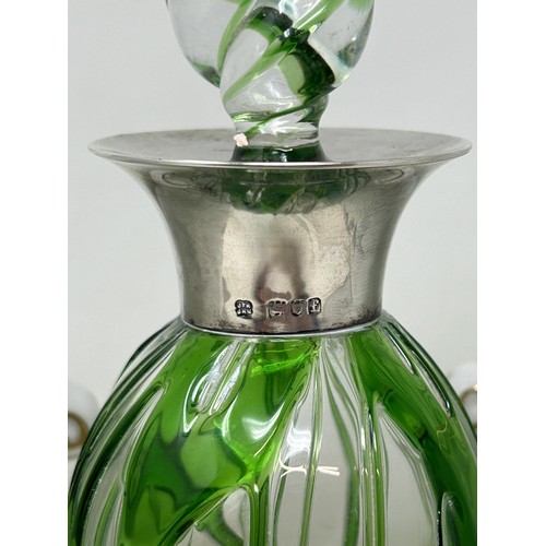 944 - A 20th century clear and green glass decanter, with a silver mount, and a pair of porcelain wine coo... 