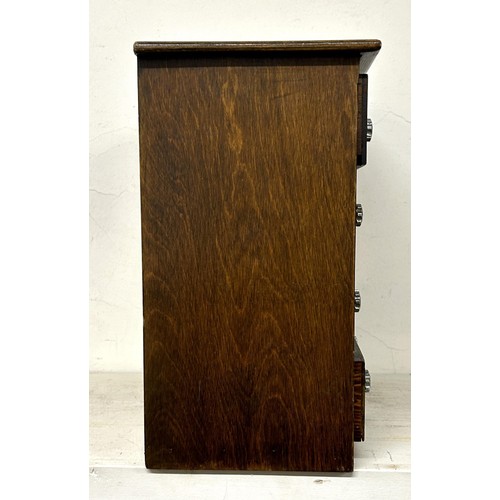 948 - A stained pine table top chest, having four drawers, 30 cm wide