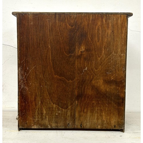 948 - A stained pine table top chest, having four drawers, 30 cm wide