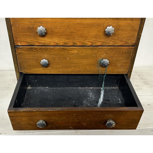 948 - A stained pine table top chest, having four drawers, 30 cm wide