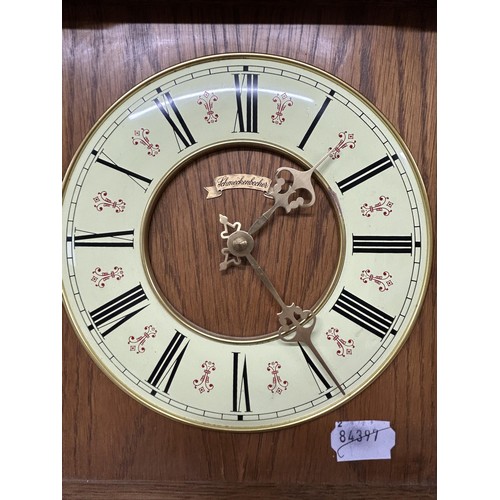 953 - A modern wall clock, in an oak case