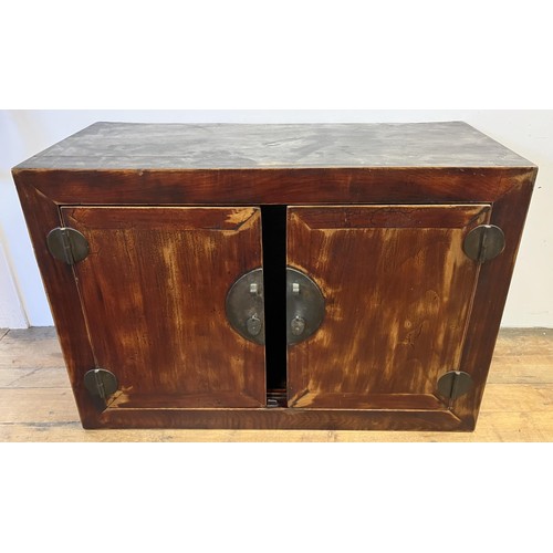 1173 - A Beijing cabinet, the top section having two cupboard doors, on a base with two further cupboard do... 