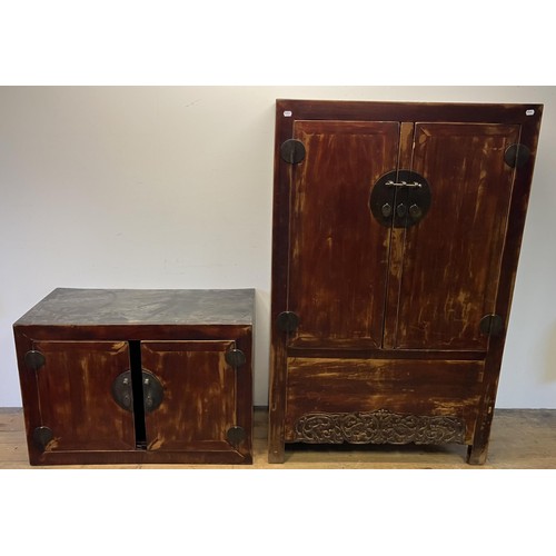 1173 - A Beijing cabinet, the top section having two cupboard doors, on a base with two further cupboard do... 