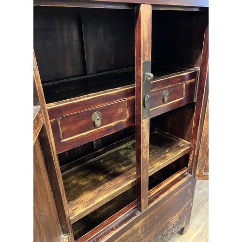 1173 - A Beijing cabinet, the top section having two cupboard doors, on a base with two further cupboard do... 