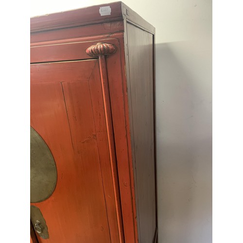 1158 - A Chinese red laquered cabinet, with metal mounts, 173 cm high x 108 cm wide