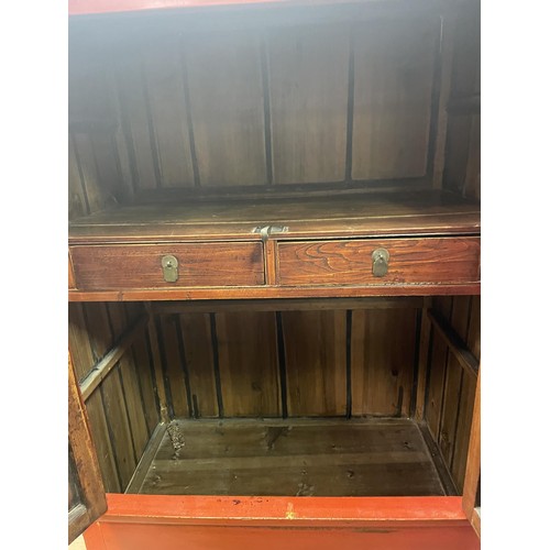 1158 - A Chinese red laquered cabinet, with metal mounts, 173 cm high x 108 cm wide