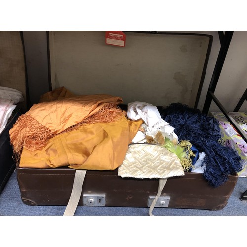 862 - A silk shawl, assorted vintage textiles and costumes (suitcase)