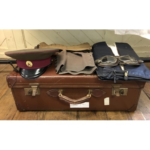 864 - A 1980s Russian USSR cap, assorted other military uniform and dress (suitcase)