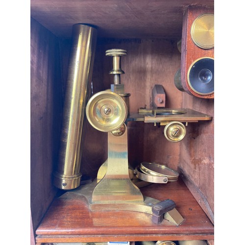 966 - A 19th century brass microscope, in a mahogany case, with a fitted drawer containing various slides