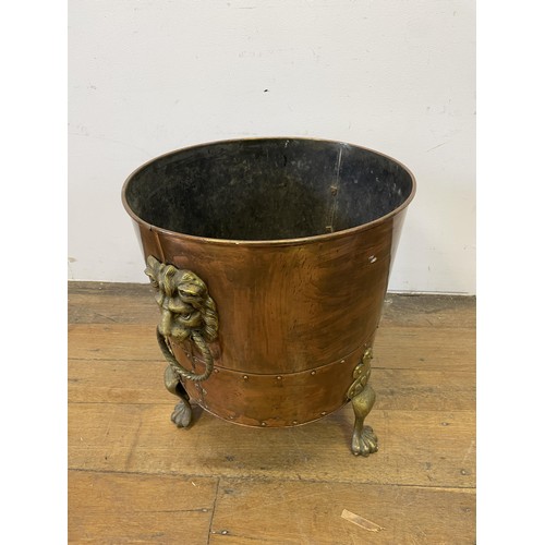 1161 - A copper and brass coal bucket, with lions head handles, 45 cm diameter, an oak table and a wine tab... 