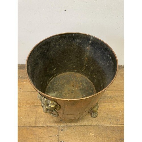 1161 - A copper and brass coal bucket, with lions head handles, 45 cm diameter, an oak table and a wine tab... 