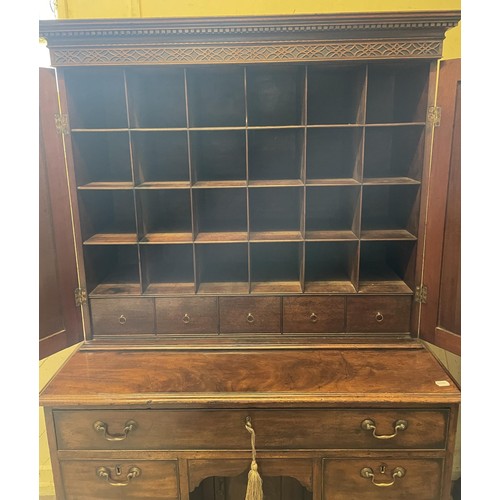 1172 - A 19th century mahogany kneehole desk, with a bookcase top having a pair of panel doors, opening to ... 