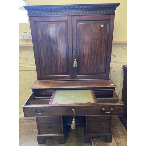 1172 - A 19th century mahogany kneehole desk, with a bookcase top having a pair of panel doors, opening to ... 