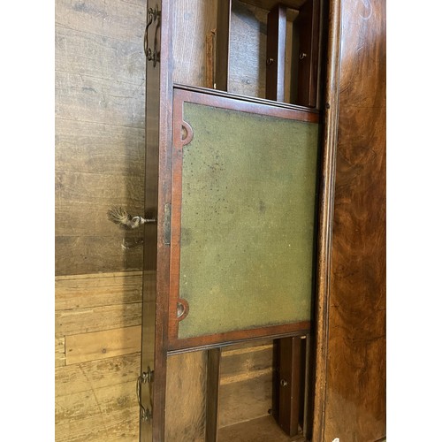 1172 - A 19th century mahogany kneehole desk, with a bookcase top having a pair of panel doors, opening to ... 