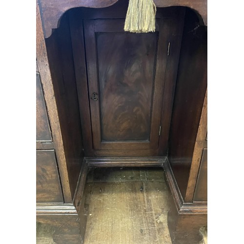 1172 - A 19th century mahogany kneehole desk, with a bookcase top having a pair of panel doors, opening to ... 