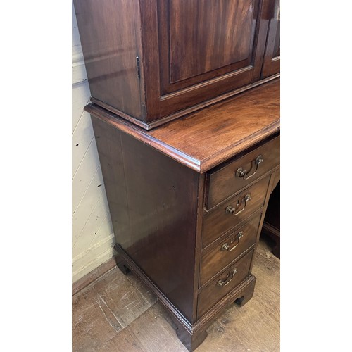 1172 - A 19th century mahogany kneehole desk, with a bookcase top having a pair of panel doors, opening to ... 