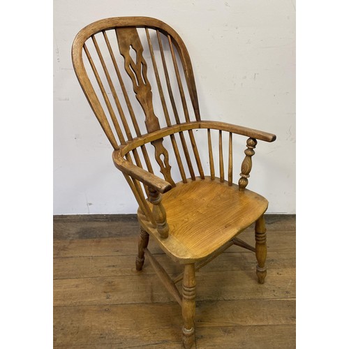 1151 - A button back nursing chair, two mahogany armchairs, and a Windsor chair