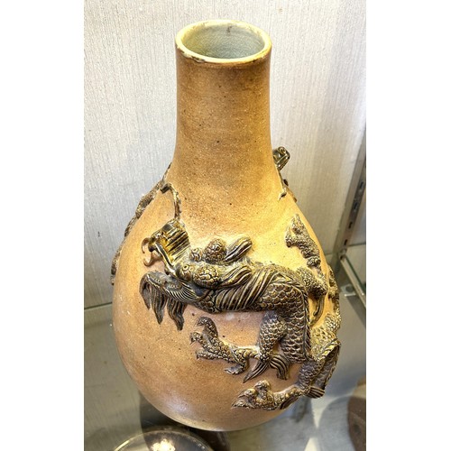 1058 - A Chinese stoneware vase, decorated dragons, 38 cm high