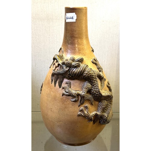 1058 - A Chinese stoneware vase, decorated dragons, 38 cm high