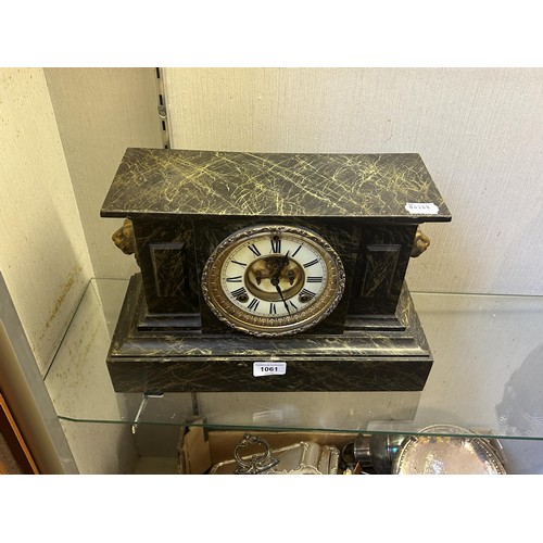 1061 - A mantel clock, in a metal faux marble case, 38 cm wide