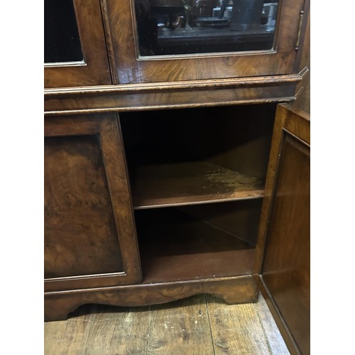 1177 - A walnut dome top corner cabinet, with two glazed doors above two cupboard doors, 90 cm wide