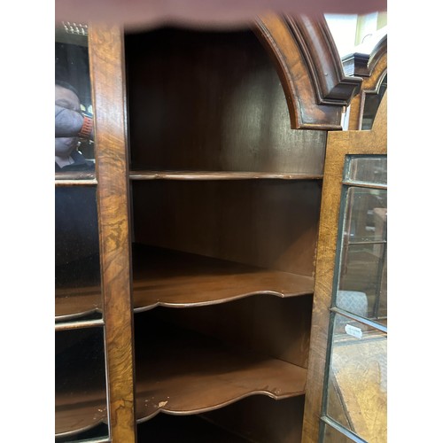 1177 - A walnut dome top corner cabinet, with two glazed doors above two cupboard doors, 90 cm wide