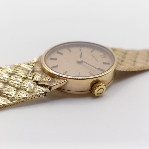 396 - A ladies 9ct gold Omega wristwatch, with a 9ct gold strap, 28.1 g all in