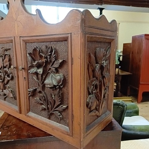 1141A - A walnut cupboard, decorated with carved flowers, 54 x 64 cm