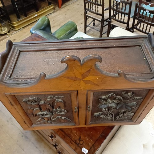 1141A - A walnut cupboard, decorated with carved flowers, 54 x 64 cm