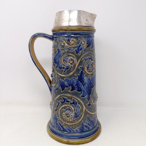 702 - A Doulton Lambeth jug, by George Tinworth, decorated floral motifs, with a silver mount, marks rubbe... 