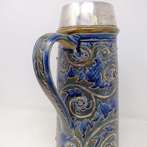 702 - A Doulton Lambeth jug, by George Tinworth, decorated floral motifs, with a silver mount, marks rubbe... 