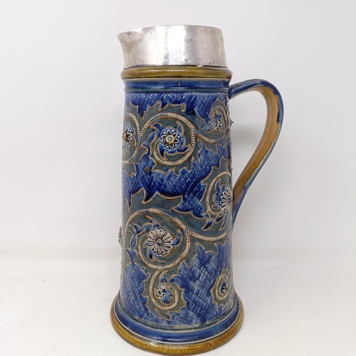 702 - A Doulton Lambeth jug, by George Tinworth, decorated floral motifs, with a silver mount, marks rubbe... 