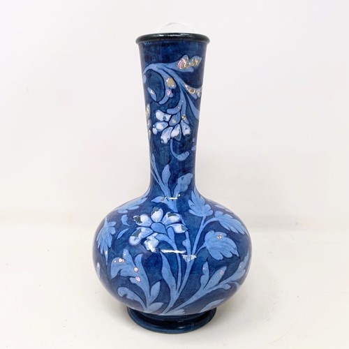 715 - A Doulton Faience vase, by Mina L Crawley, blue ground, decorated flowers, 21 cm high