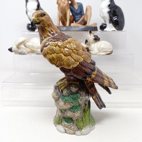 724 - A Royal Doulton figure of a Golden Eagle, RDA36, Buddies HN2546, a figure of a reclining dog, and as... 