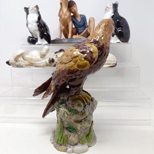 724 - A Royal Doulton figure of a Golden Eagle, RDA36, Buddies HN2546, a figure of a reclining dog, and as... 